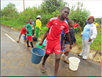 group of kids fetching water
