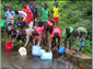 group of kids fetching water